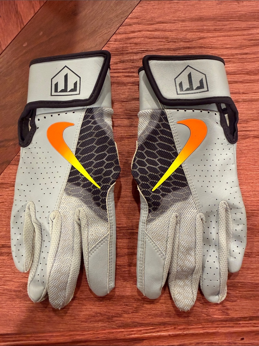 Nike Gray Baseball Gloves with Orange Swoosh